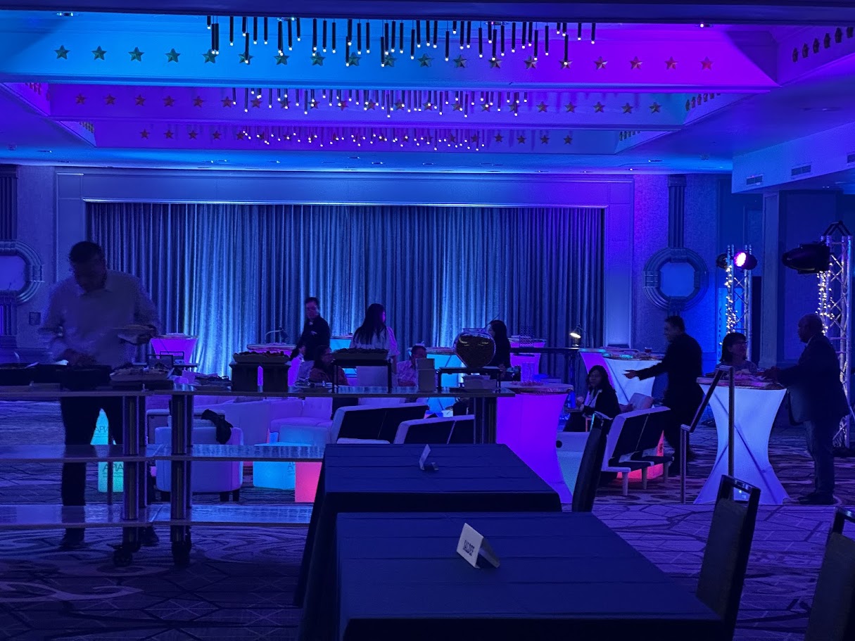 Wireless uplighting washing a ballroom in blue and magenta